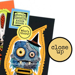 A close-up of a handmade Halloween greeting card featuring a stitched blue zombie-like ghost character on a black card base with orange jagged trim. The Halloween Cards are made with Halloween Collage Sheets and Rubber Stamped Halloween Words.