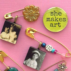 Collection of decorative brooches with floral and vintage photo designs on a pink background.