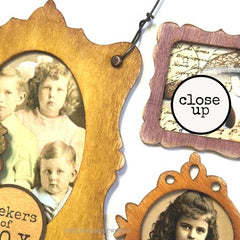 Close-up of vintage-style wooden photo frames with old photographs inside.