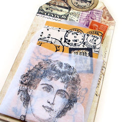 close up of Artist Face rubber stamped tag